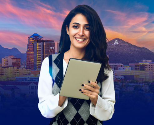 young adult holding a tablet smiling with Arizona background