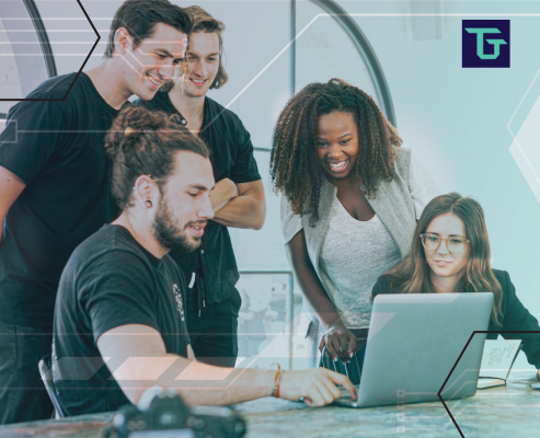 A diverse group of young professionals collaborating around a laptop in a modern office setting, symbolizing Arizona’s evolving tech talent landscape. The image reflects innovation, teamwork, and the future of workforce development in the state’s growing semiconductor and software sectors. Includes Technical Talent Group branding.