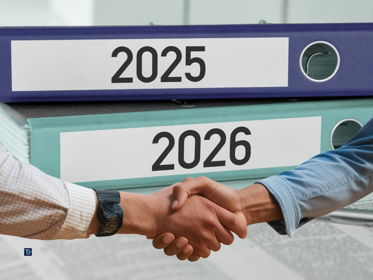 Handshake in front of binders labeled 2025 and 2026, representing the 2026 technical hiring dashboard and a year-to-year hiring strategy reset